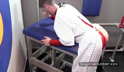 Guyzin2Rubber Fetish Clinic sees Dr Bennett man-handling his Patient's huge cock.Both in hot Rubber